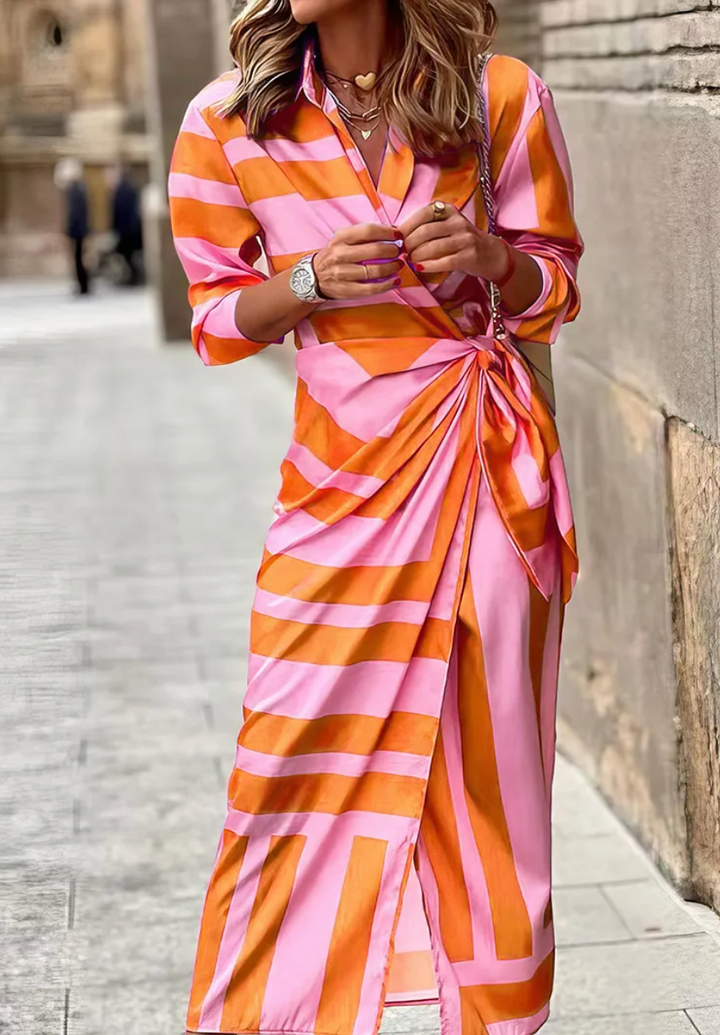 Chic women's printed wrap dress featuring a vibrant, colorful pattern. Ideal for summer casual or elegant wear.
