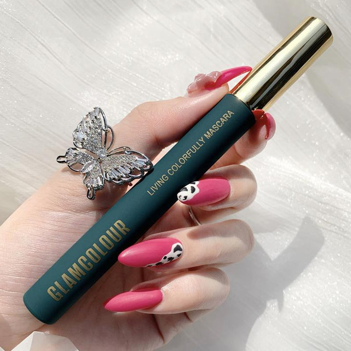 Yellow colored skinny mascara applied on lashes, an eye-catching and waterproof cosmetic product