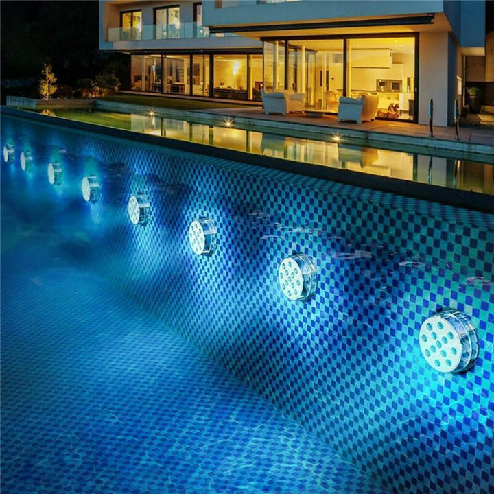 Close-up of a vibrant RGB submersible LED light, showing waterproof design and bright illumination.
