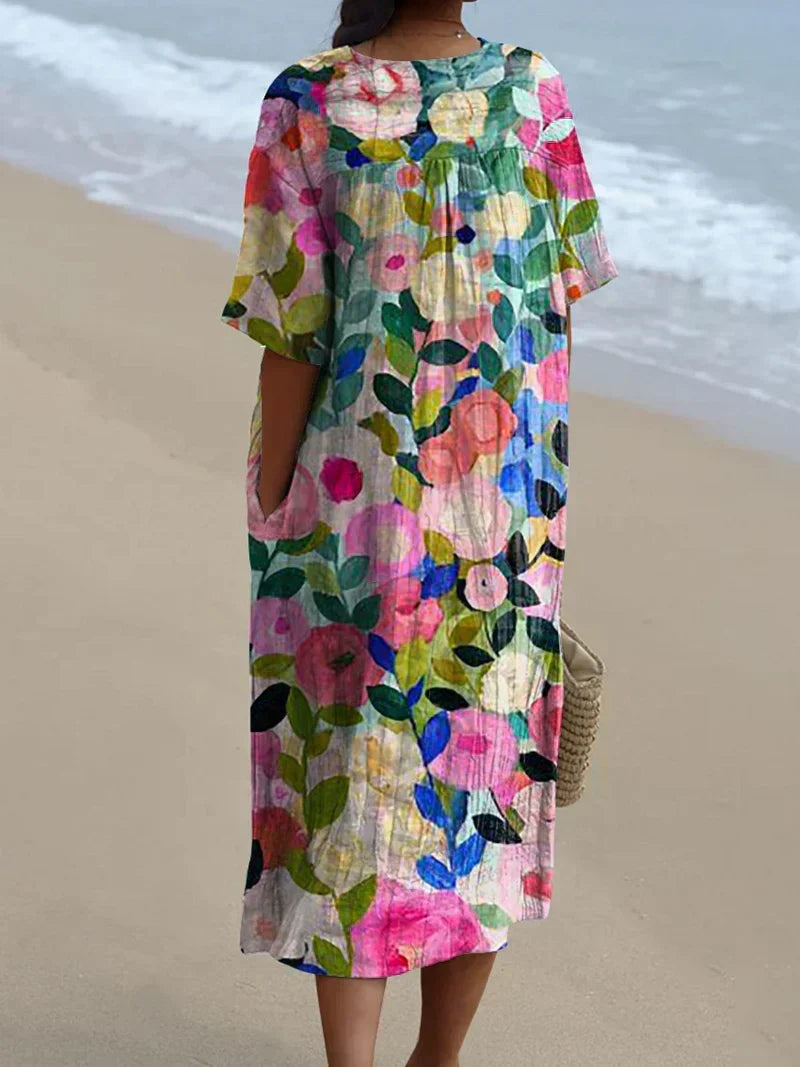 Elegant women's flowy floral midi dress with a colorful garden print, ideal for comfortable spring and summer fashion.