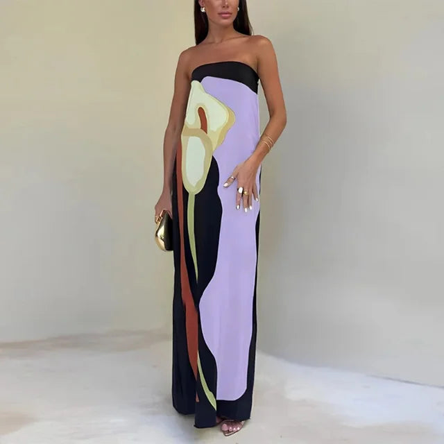 Women's vibrant patterned maxi dress, flowing strapless design for elegant summer beach resort wear.
