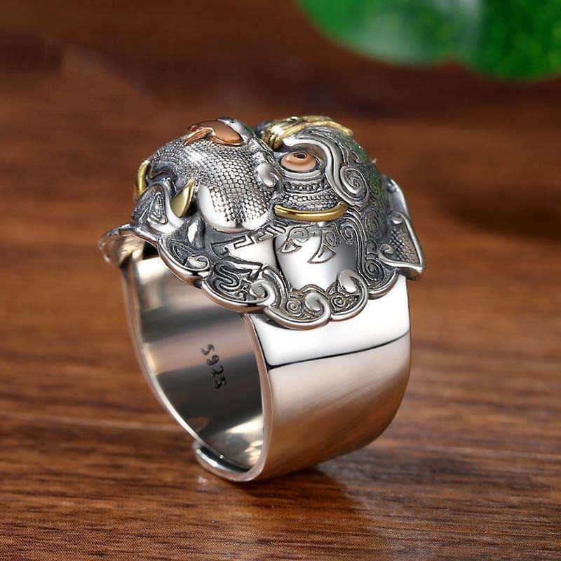 Detailed shot of a lucky Pixiu charm on a vintage adjustable copper ring, mythical jewelry