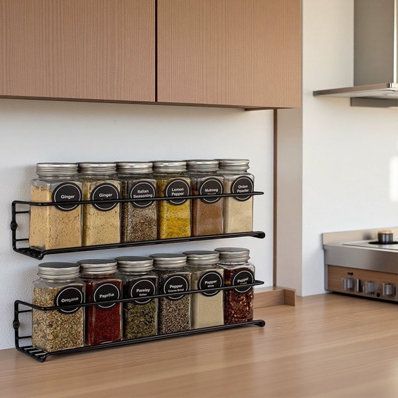 Kitchen storage solution: wall-mounted carbon steel spice rack holding various seasoning containers.