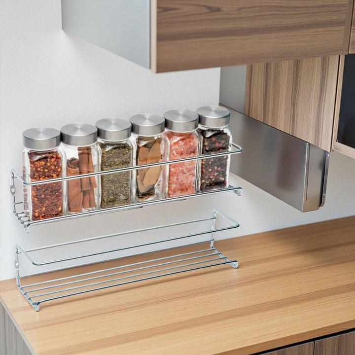 Modern kitchen with a wall-mounted carbon steel spice rack, enhancing cabinet storage.