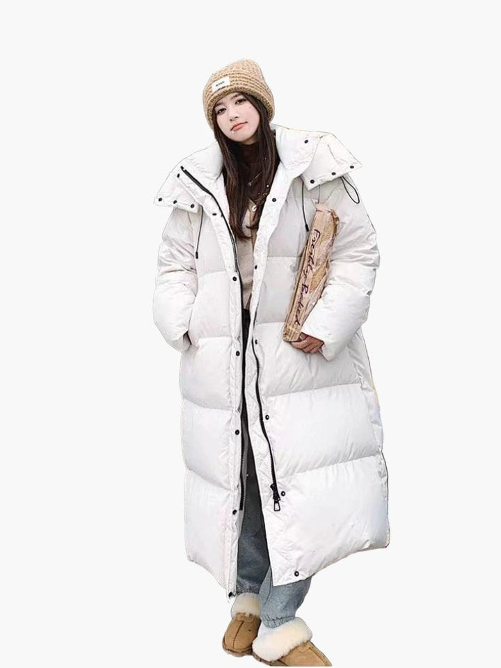 Long quilted puffer coat for women, featuring a cozy hood, an essential winter outerwear item