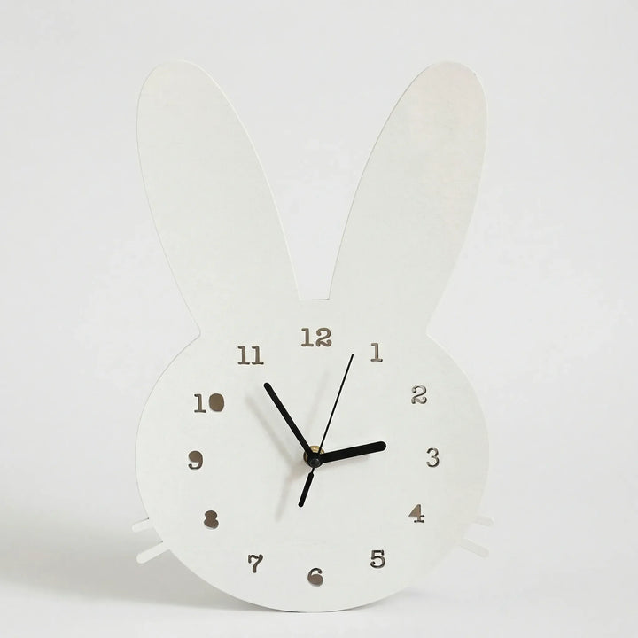 Decorative bunny shaped wall clock in white. Silent operation, great for a cozy kids' room or nursery decor.