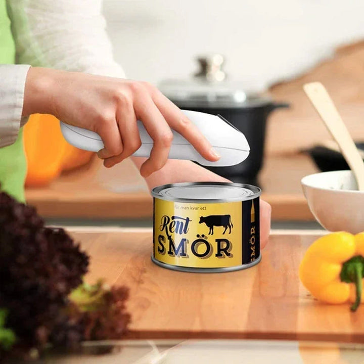 Electric automatic can opener in action, effortlessly opening a standard food can