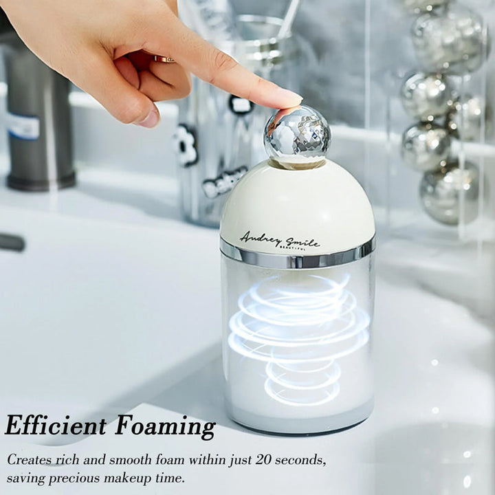 White electric facial foam maker with brush head, perfect for deep cleansing skincare routine.