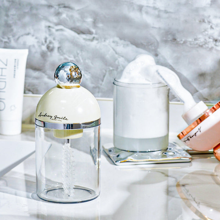 Close-up of the soft brush head on an electric facial foam maker, for gentle yet deep cleaning.