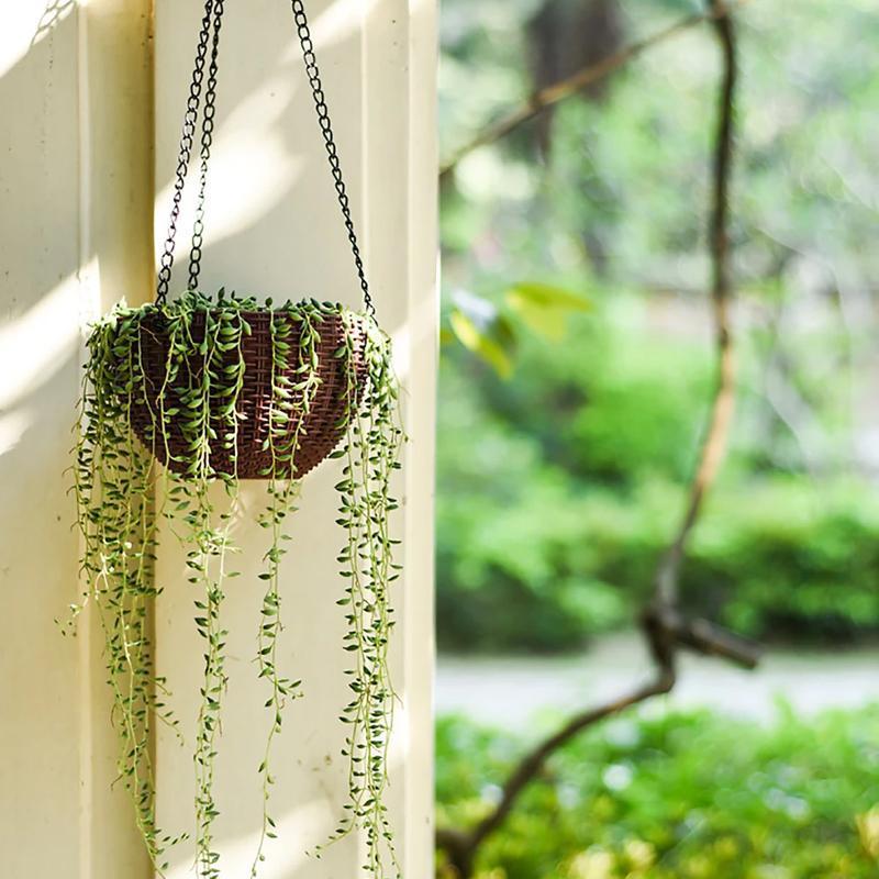 White self-watering hanging planter, ideal for indoor or outdoor plant self-care and garden decor.