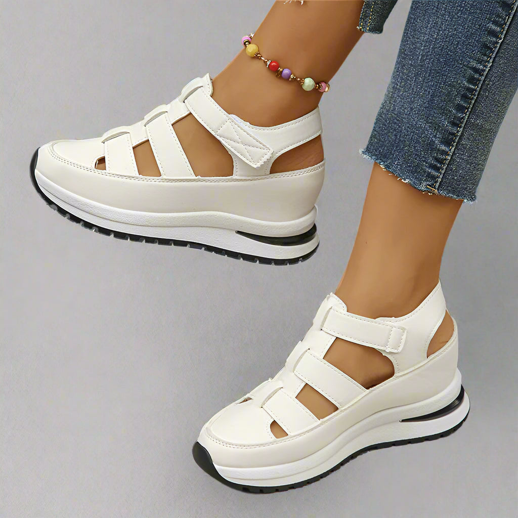 White women's platform sneakers with cutout design, perfect for spring casual wear and comfort.