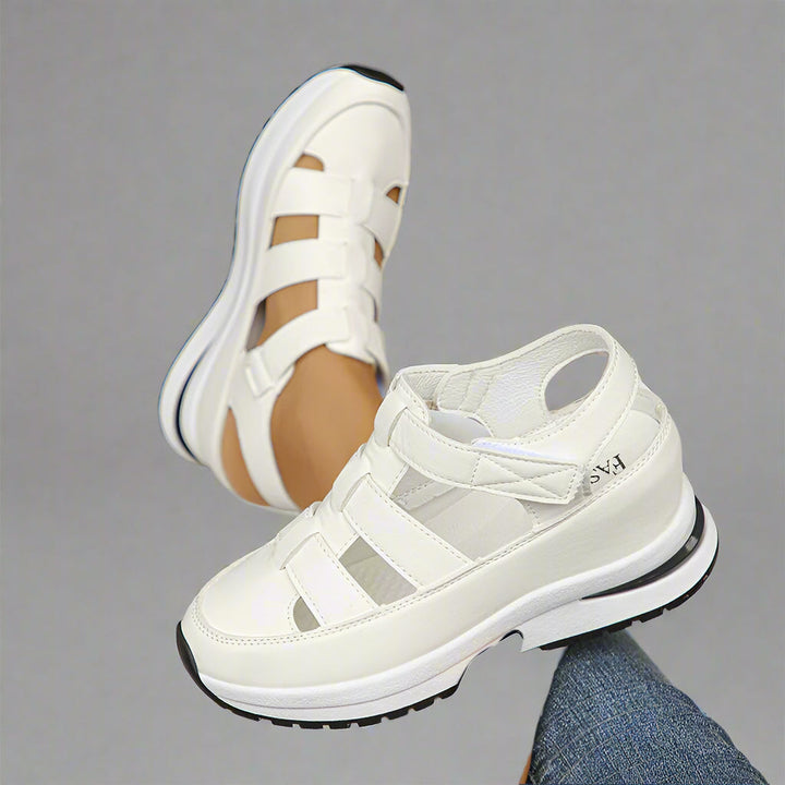 Black women's fashion sneakers featuring a platform sole and stylish cutouts, ideal for everyday.