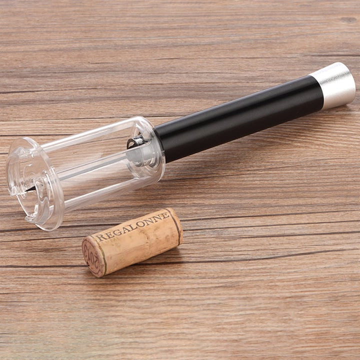 Close-up of Wino On The Go wine opener needle piercing cork, air pressure mechanism in action