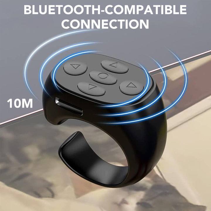 Compact Bluetooth fingertip remote for smartphones, shown controlling music playback, perfect phone accessory.