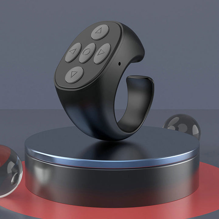 Close-up of the universal Bluetooth finger remote, highlighting its sleek design and easy-to-press buttons.