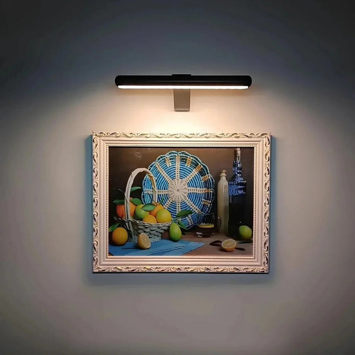 Modern wireless LED picture light enhances art display. Rechargeable, dimmable for stylish home accent & decor.