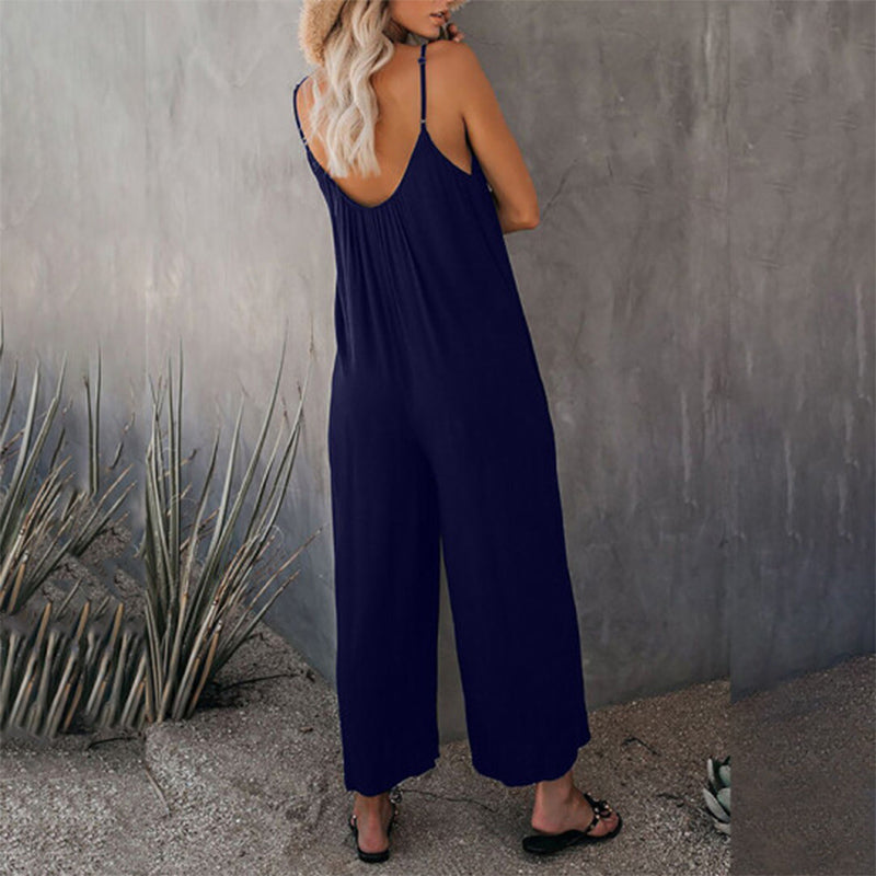 Side view of woman in a solid color wide-leg jumpsuit, highlighting the loose fit & casual elegance