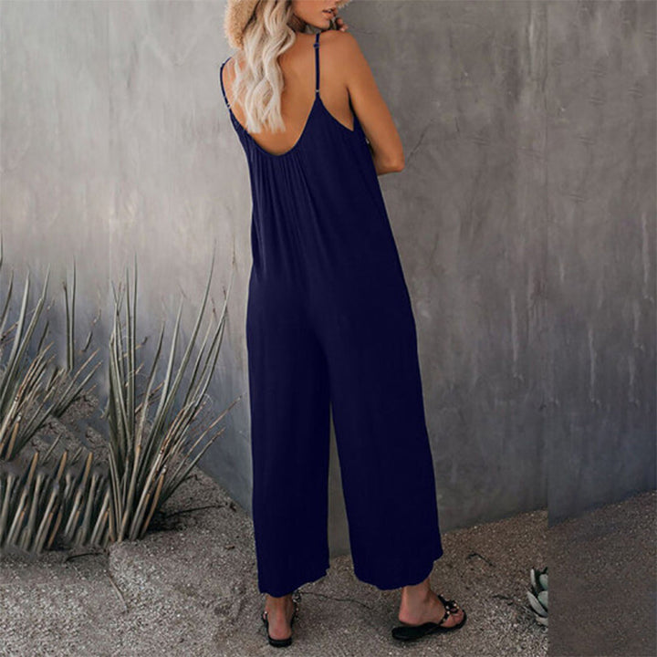 Side view of woman in a solid color wide-leg jumpsuit, highlighting the loose fit & casual elegance