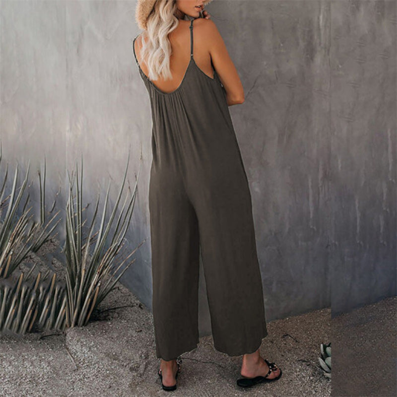 Woman sitting casually in a stretchy wide-leg jumpsuit, emphasizing comfort for all-day wear