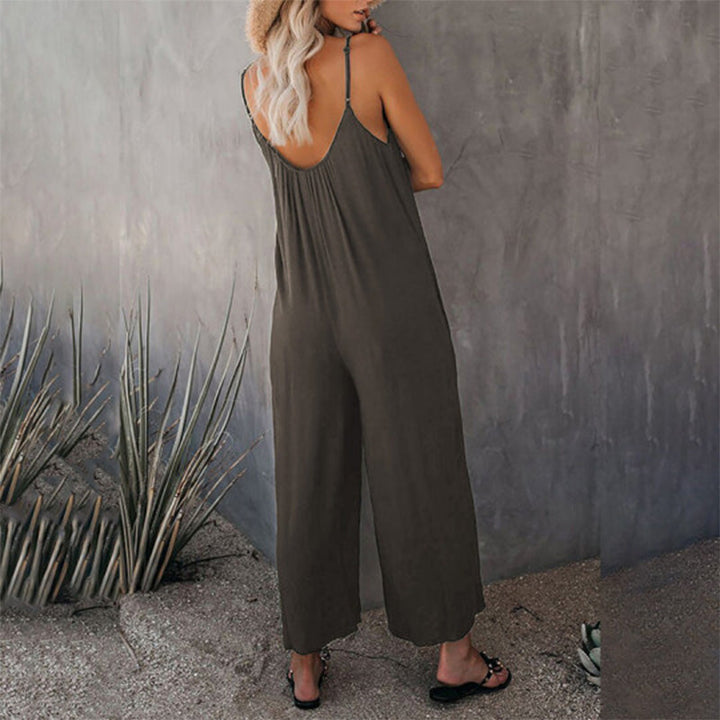 Woman sitting casually in a stretchy wide-leg jumpsuit, emphasizing comfort for all-day wear