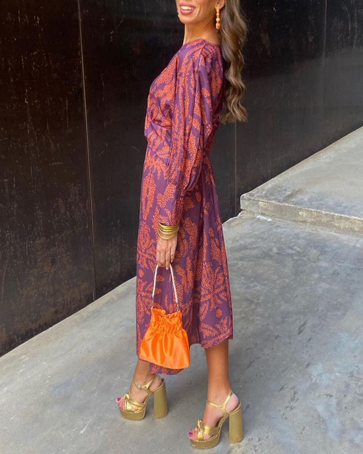 Formal women's printed maxi dress, A-line silhouette with knot detail, suitable for wedding guests and cocktail parties.