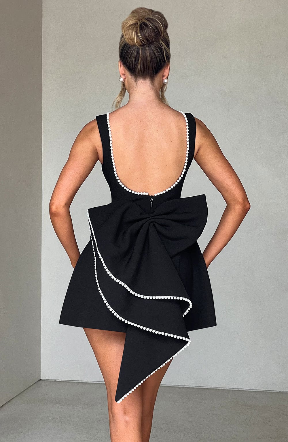 Modern A-line mini dress for women, showcasing classic pearl trim. Perfect for homecoming & evening wear.