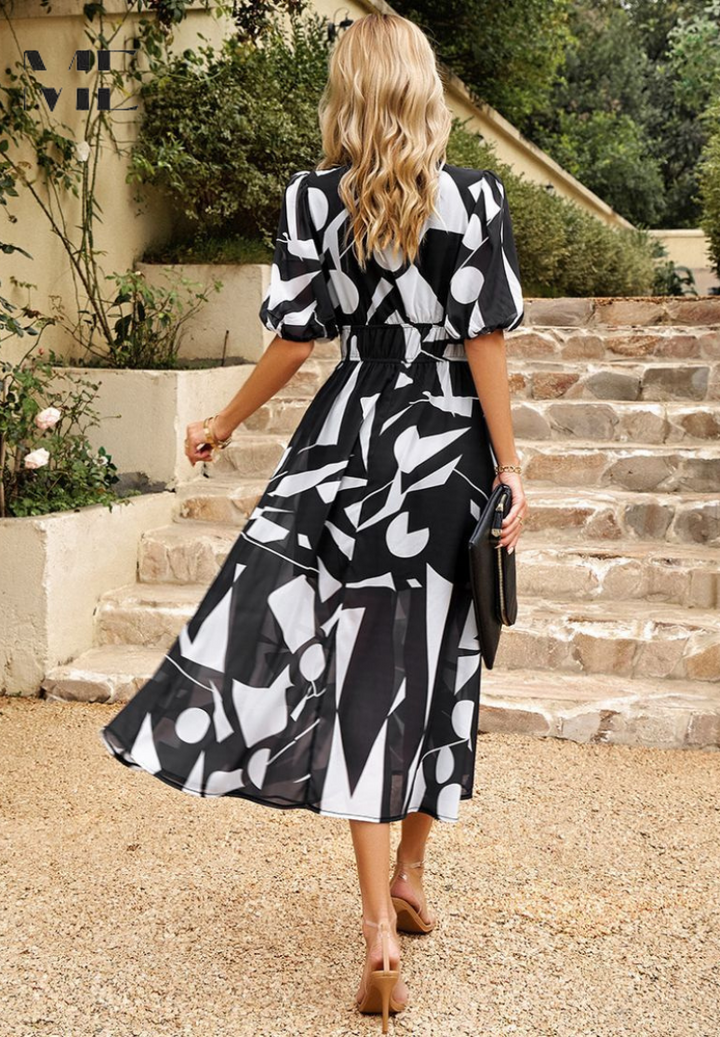 Close-up of the neckline and abstract print on a women's versatile midi dress