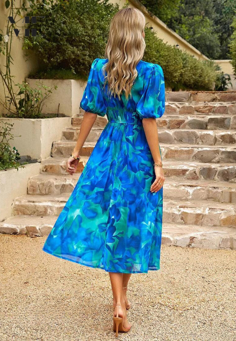 Belt detail on a women's abstract print midi dress, cinching the waist for a flattering fit
