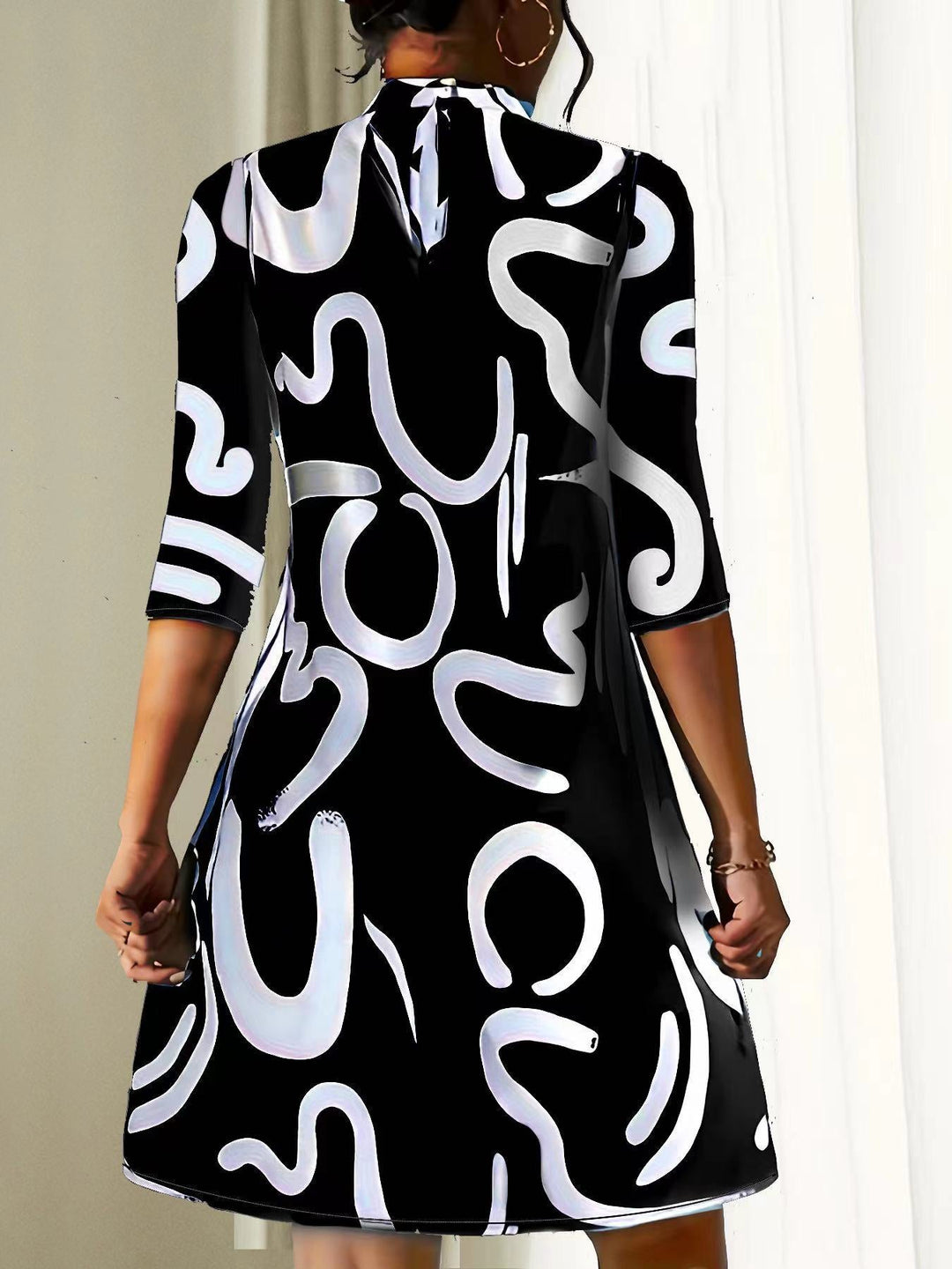 Comfortable women's mock neck dress. Loose-fit, three-quarter sleeve, abstract print for casual summer style.