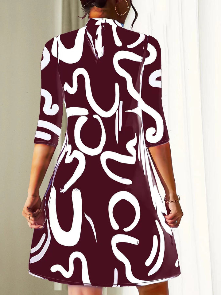 Modern women's abstract print mock neck dress. Loose-fit, three-quarter sleeve, knee-length for comfortable casual style.