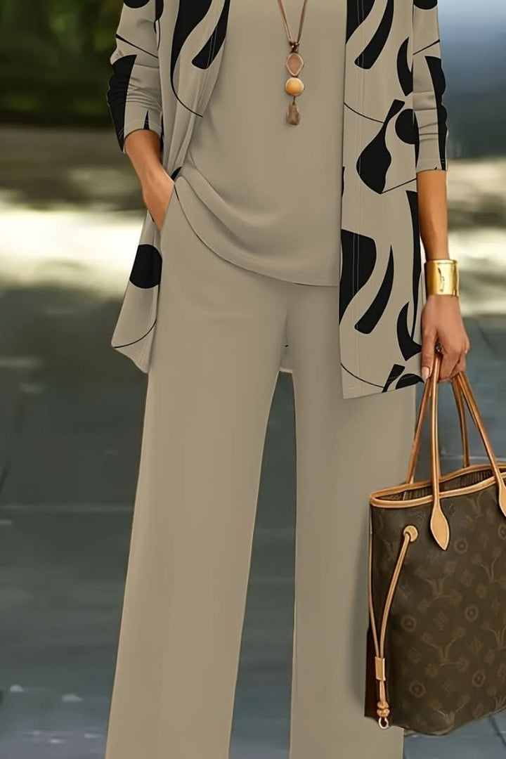 Women's abstract print three-piece set with a flowing duster, camisole, and wide-leg pants for a modern, chic look.
