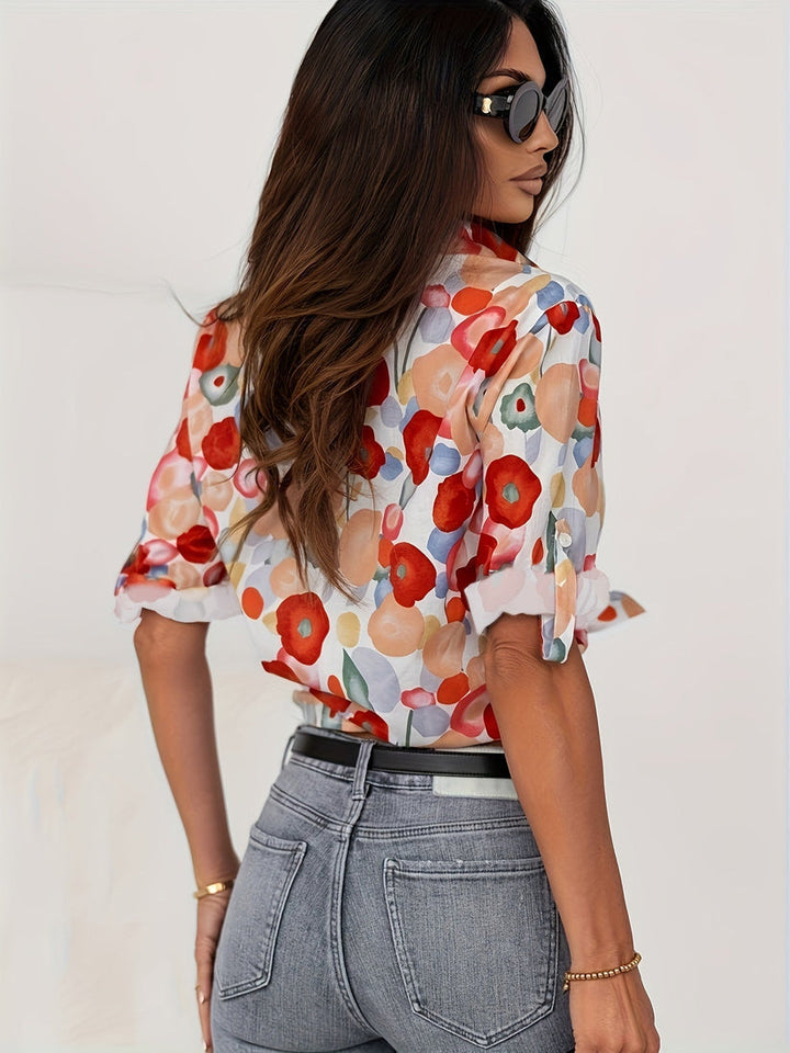 Vibrant women's floral print blouse with abstract art, button-down front, long sleeves, versatile and boho-chic.