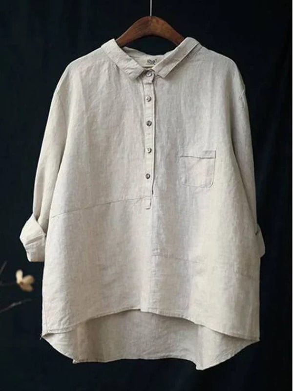 Ladies asymmetrical hem button-up blouse in a casual, relaxed fit. Versatile long-sleeve top.
