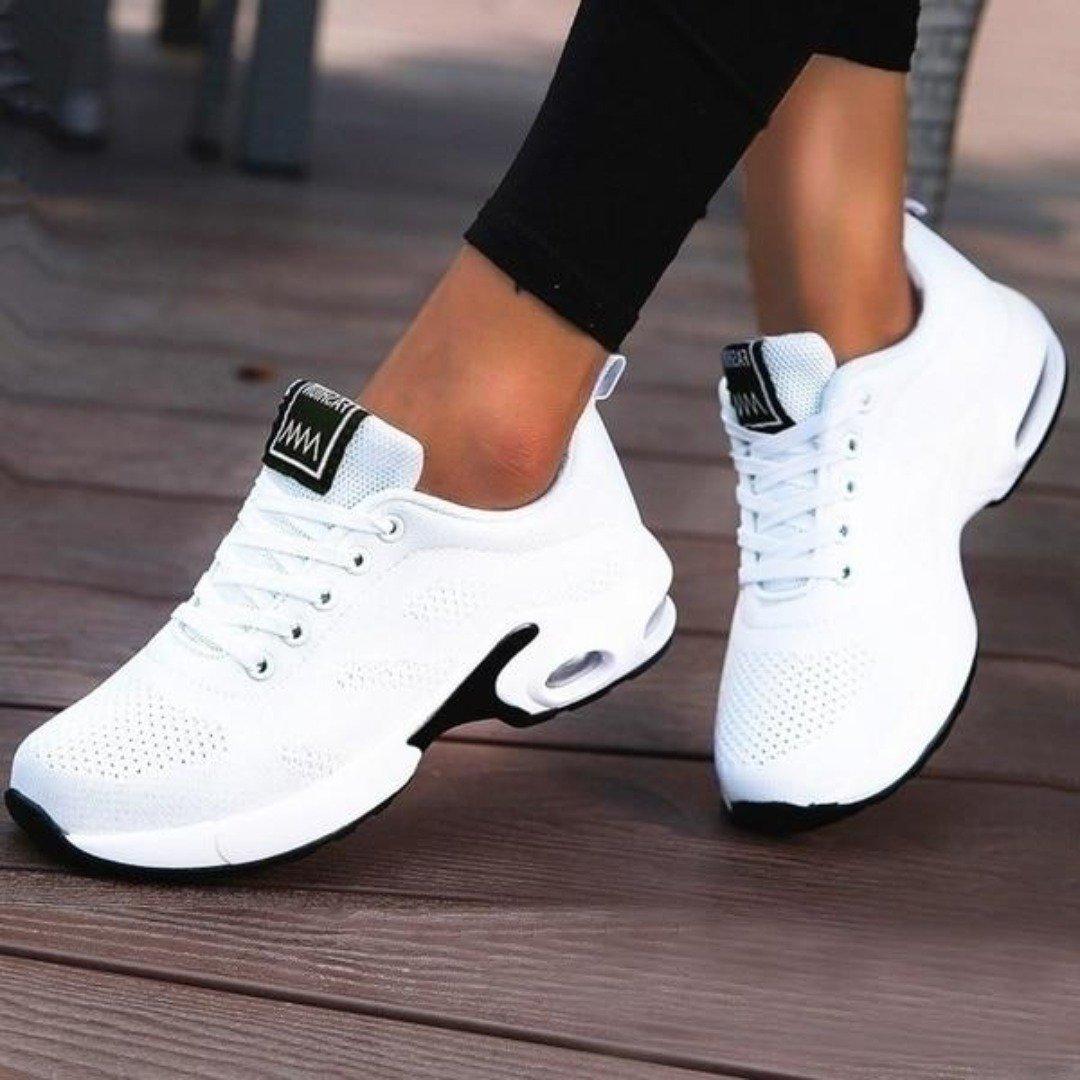 Pair of women's running shoes, black with neon green details, ideal for fitness and everyday wear