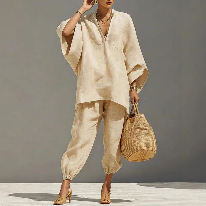 Stylish two-piece women's lounge set featuring an elegant batwing sleeve top and matching bottoms.