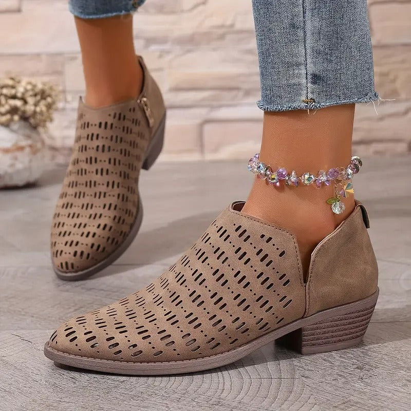 Stylish women's brown ankle boots with strategic cutouts, offering a breezy feel for casual summer footwear