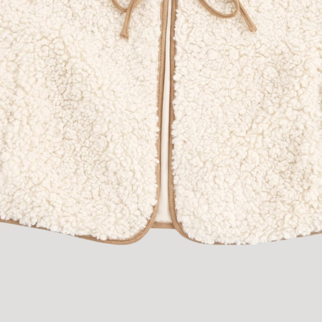 Sleeveless beige vest for women with a fashionable tie-front detail, versatile.