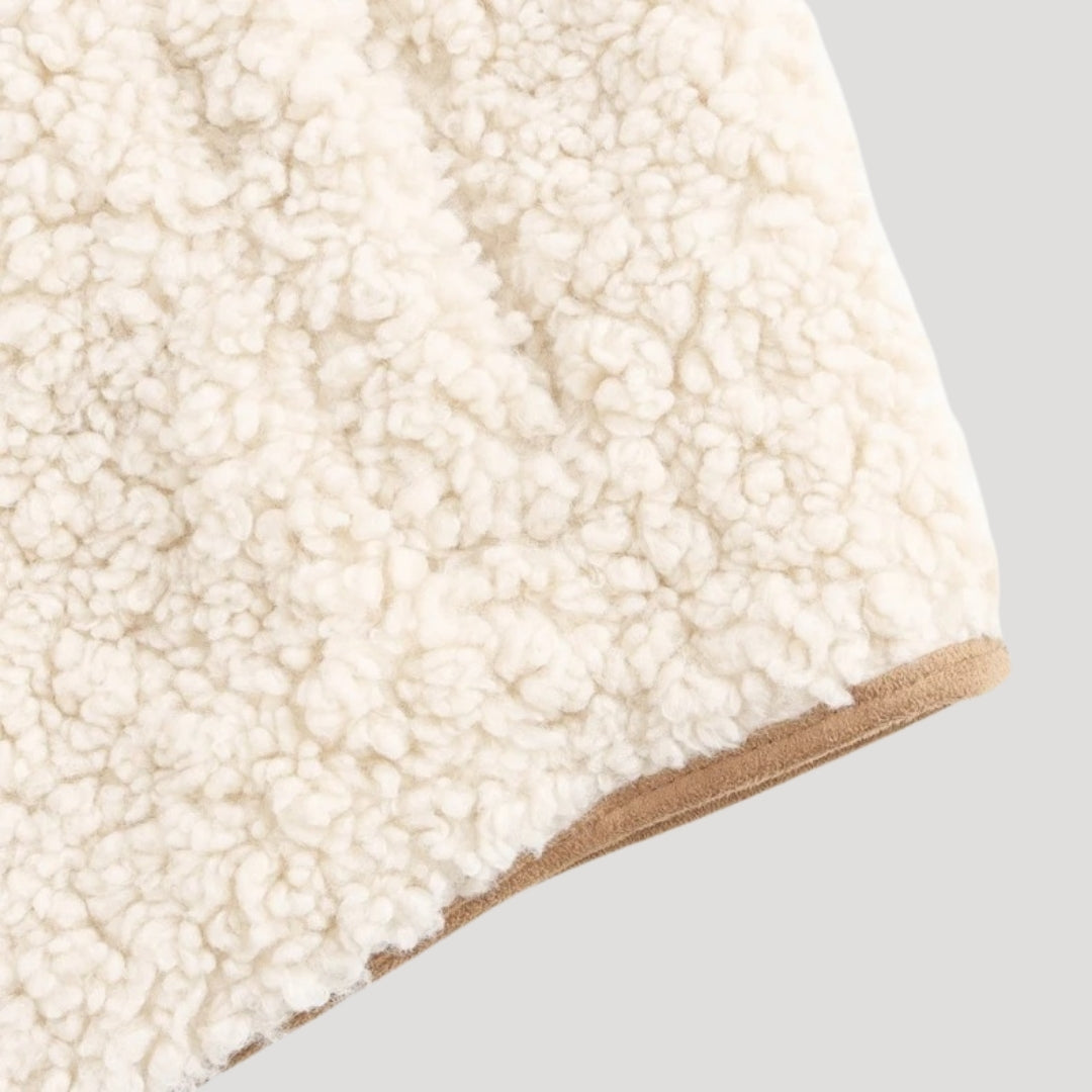 Close-up of the tie-front detail on a women's lightweight cozy beige vest.