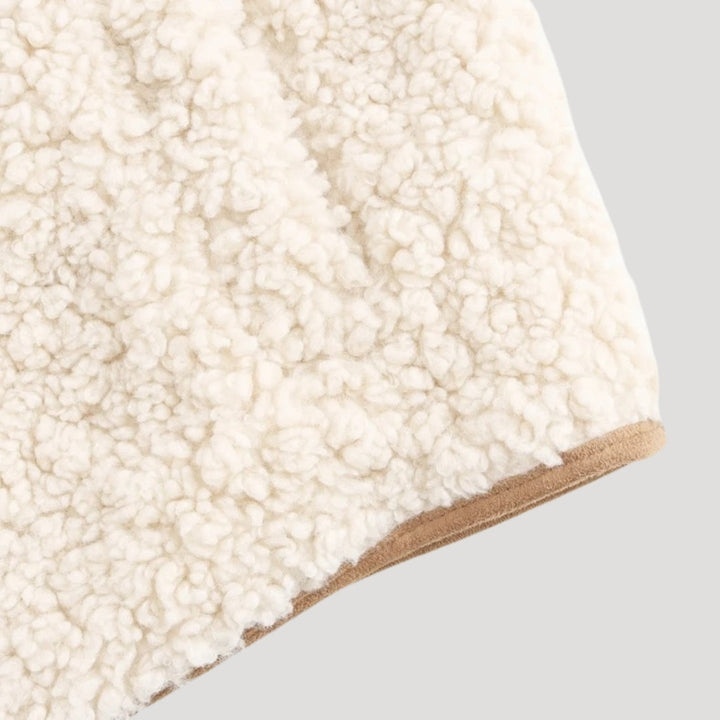 Close-up of the tie-front detail on a women's lightweight cozy beige vest.