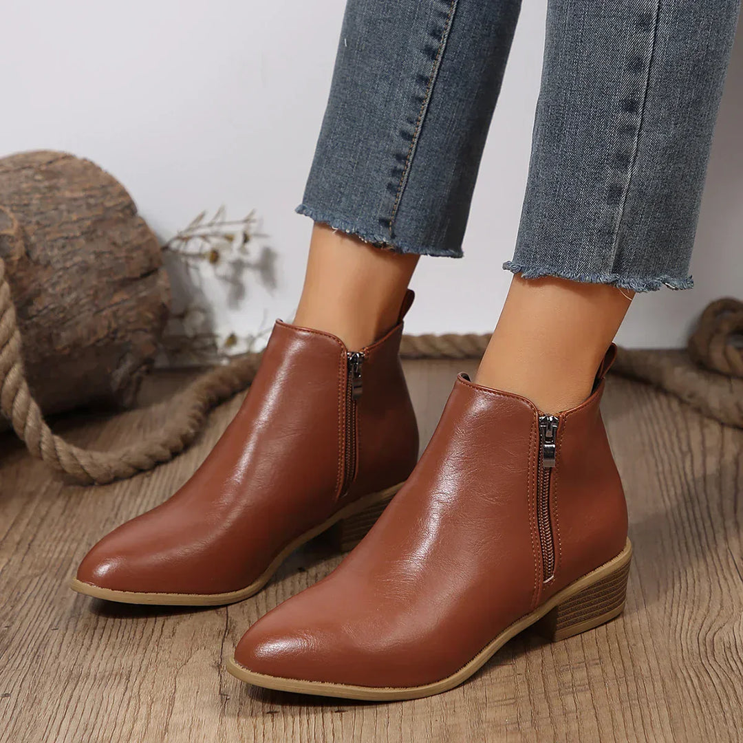 Close-up of side zip on women's black ankle boot, showcasing comfortable and casual footwear details