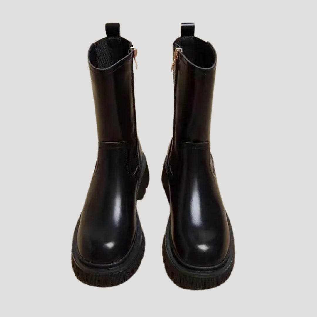 Fashionable women's mid-calf boots in black with a chunky sole, ideal for spring outfits.