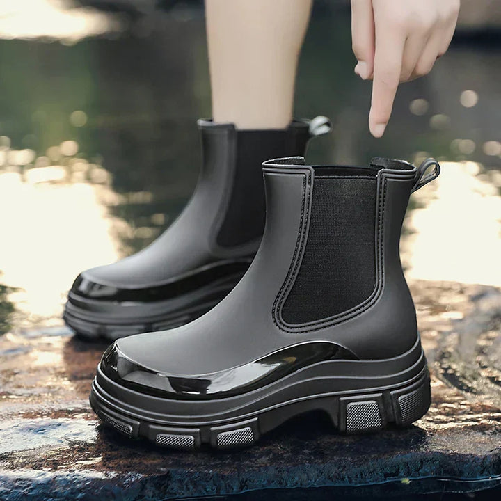 Women's black chunky platform Chelsea rain boots, waterproof and stylish for fall weather. Comfortable ankle boots.