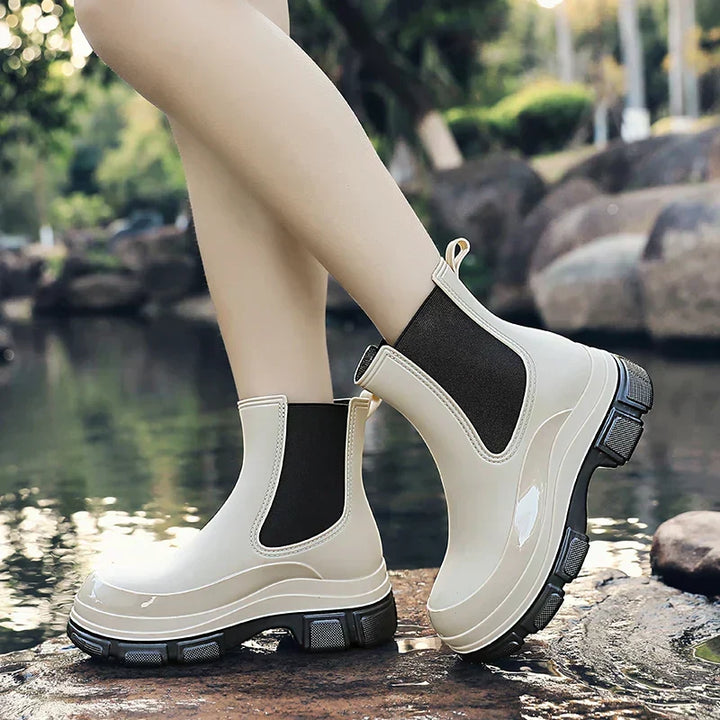 Comfortable women's black Chelsea rain boots with a durable chunky platform. Perfect waterproof footwear for wet weather.