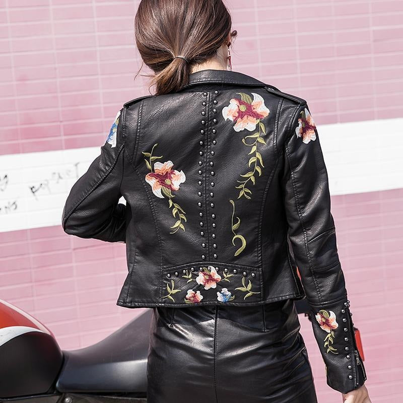 Edgy women's faux leather biker jacket with chic floral embroidery, a fashion statement piece.