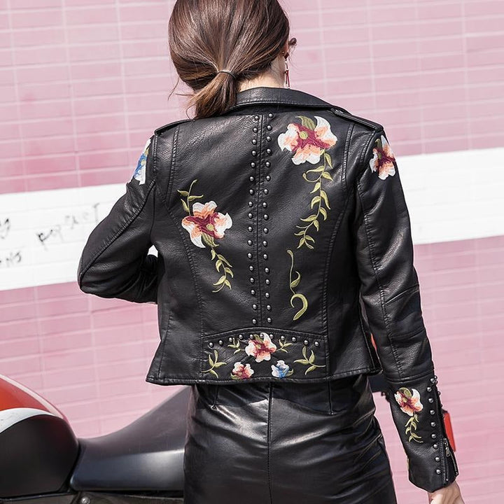 Edgy women's faux leather biker jacket with chic floral embroidery, a fashion statement piece.