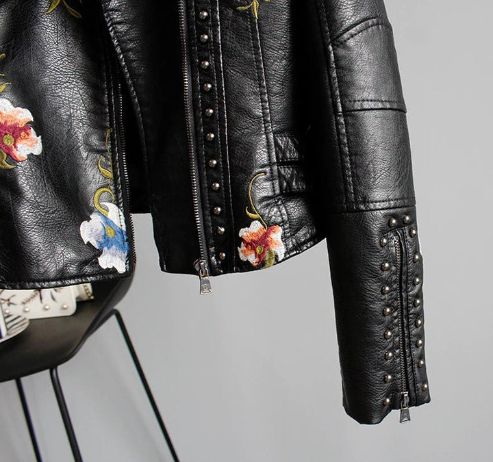 Chic embroidered women's biker jacket. Faux leather with floral details for an edgy style.