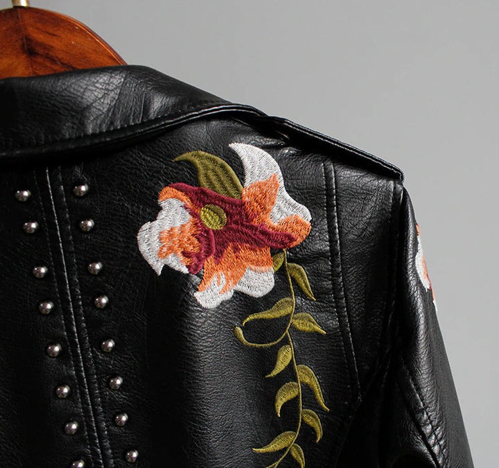 Elegant women's "Eleonora" embroidered biker jacket, showcasing intricate floral art on faux leather.