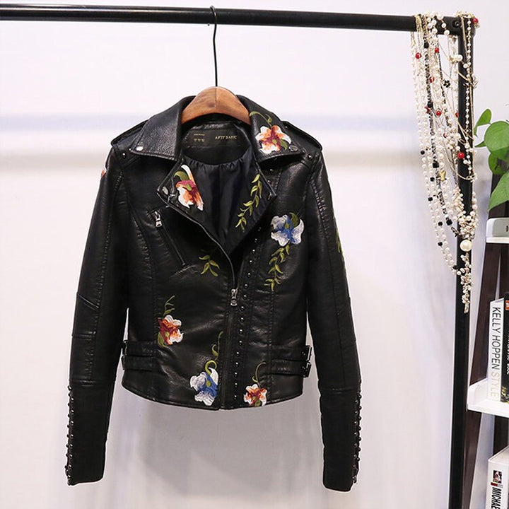 Stylish women's embroidered faux leather jacket with an asymmetrical zipper and delicate floral stitching.