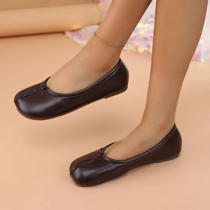 Stylish women's black flats with a unique split toe, perfect for modern outfits.