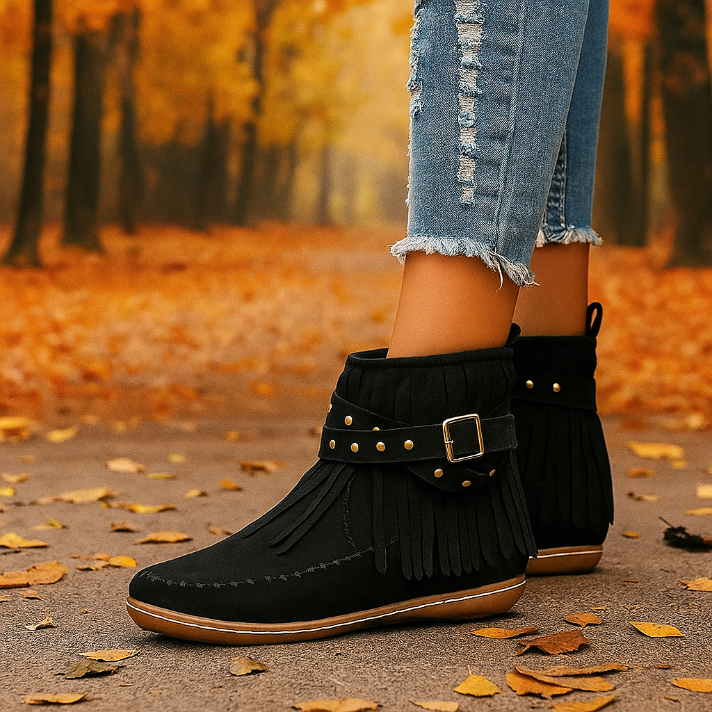 Model wearing women's black fringe ankle boots, showcasing boho chic look